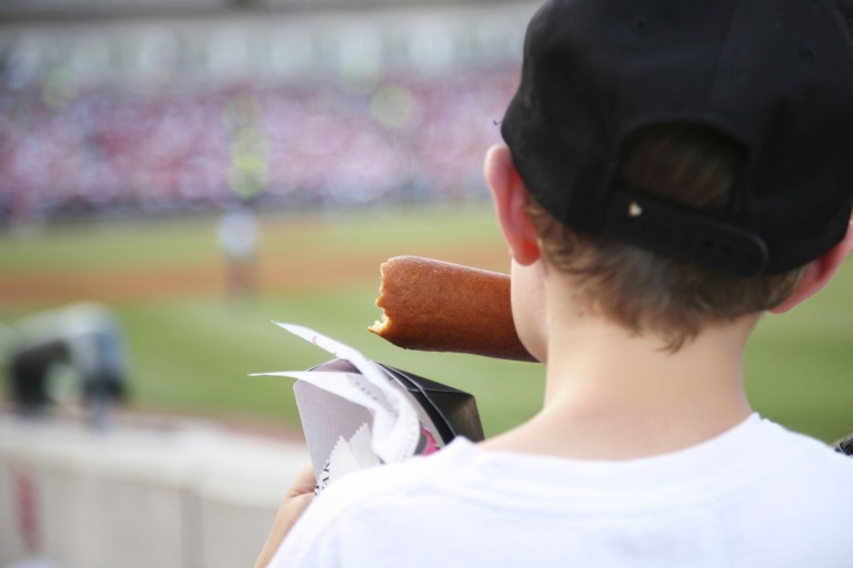 アメリカンドッグを食べるアメリカの子供
